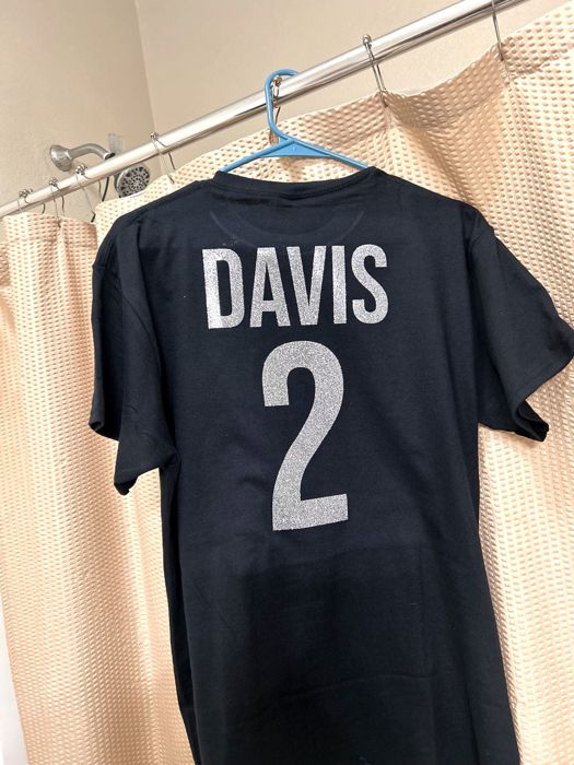 Black shirt with a custom name and number in silver glitter, jersey style