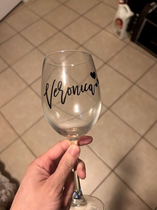 Wine glass with a custom name in black vinyl