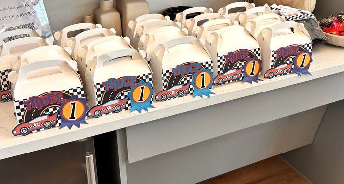 Row of custom race car themed party favor boxes