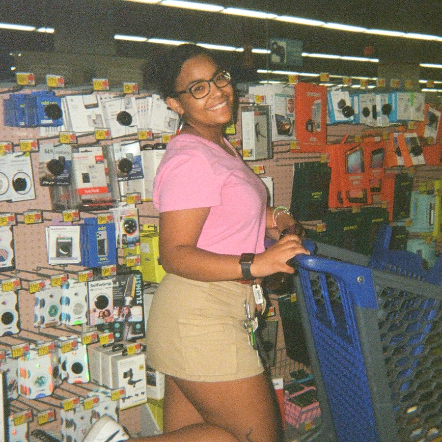 Tori, the maker behind Tori's Touch, smiling in her signature pink